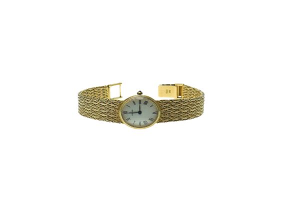 ladies yellow gold fourteen karat concord mechanical wind up movement watch with white oval shape dial with black roman numerals with mesh style band with a tri fold clasp