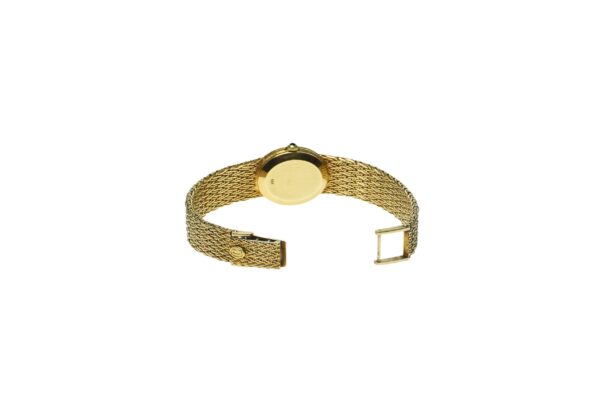 ladies yellow gold fourteen karat concord mechanical wind up movement watch with white oval shape dial with black roman numerals with mesh style band with a tri fold clasp