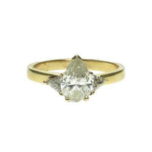 yellow gold fourteen karat engagement ring with center pear shape fractured filled diamond approximately one point zero zero enhanced by one trillion shape diamond approximately zero point zero seven each side