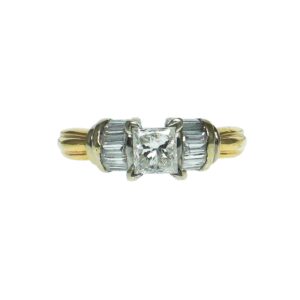 yellow gold fourteen karat two tone setting with princess cut center diamond approximately zero point fifty nine carat accentuated with fourteen baguette diamonds on sides approximately zero point zero four each