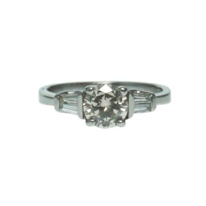 ladies platinum engagement ring with center round brilliant cut diamond approximately one point zero zero carat accentuated with two tapered baguette diamonds on each side