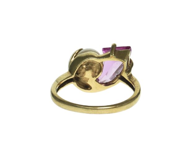 ladies yellow gold fourteen karat with a tapered trapeze cut pink sapphire with a cultured pearl