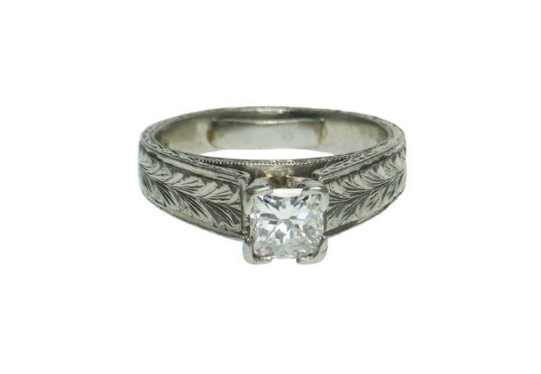 platinum solitaire nature engraved design mounting with four prong set princess cut diamond weighing approximately zero point seventy five points and inner shank ring size adjuster