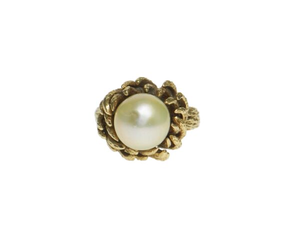 bold yellow gold fourteen karat bark style mounting with center cultured pearl